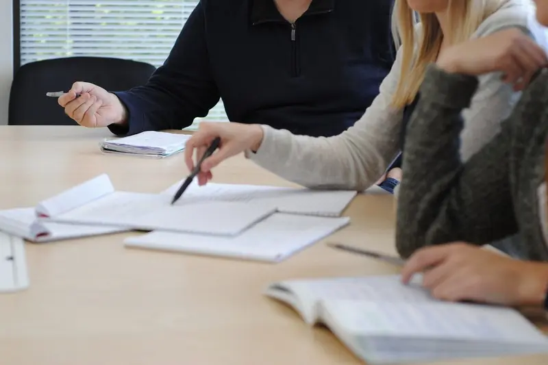 A team working through notes together around a table